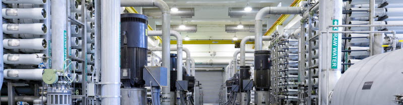 Großes Rack aus metallischen Zylindern für die Umkehrosmose verbunden mit Rohrleitungen in einer Wasseraufbereitungsanlage